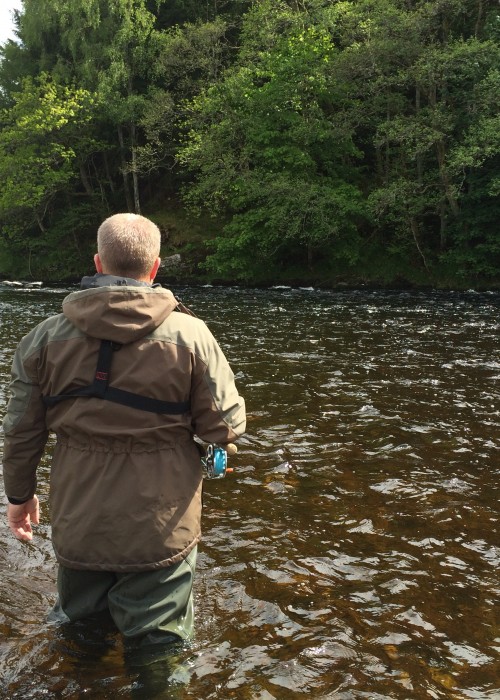 This guided salmon fishing guest was photographed as he was approaching the Rock Pool neck on the Lower Tummel salmon beat of the River Tummel near Moulinearn. Look at the perfect streamy fly water here which merges into the deeper salmon holding water in front of the trees.
