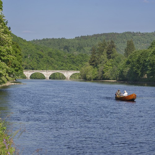 Here's a lovely shot of the traditional Tay salmon boat heading up river with the commanding Telford Bridge in Dunkeld in the distance. This fine Summer shot was taken on the Dunkeld House salmon beat of the River Tay in Perthshire.