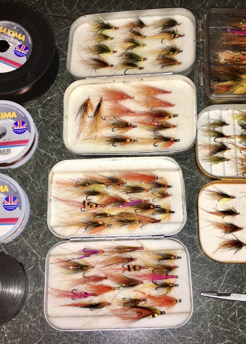 Here's a few different Wheatley of England salmon fly boxes stacked with a few deadly salmon fly patterns. There's Maxima fly leader material there too along with electric tape to secure the rod joints from loosening off while Spey casting. And let's not forget the forceps for the easy unhooking of salmon prior to release.