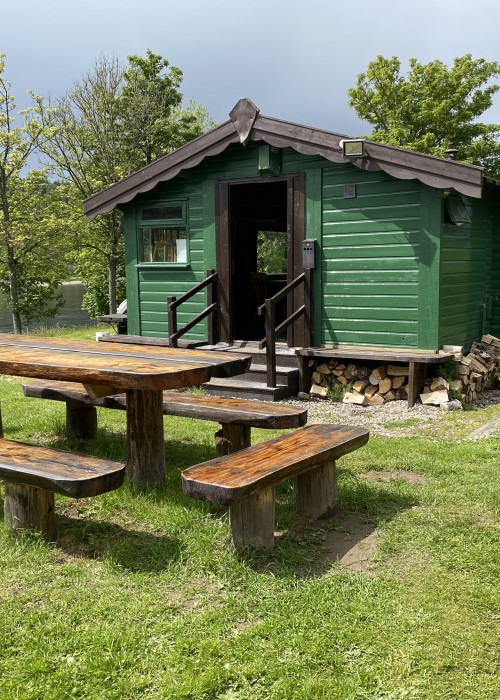 This lovely green fishing hut is located between Pitlochry & Dunkeld in the River Tay Valley. This is the Lower Kinnaird fishing hut and its outside luncheon table.
