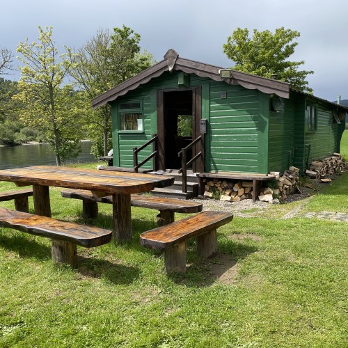 This lovely green fishing hut is located between Pitlochry & Dunkeld in the River Tay Valley. This is the Lower Kinnaird fishing hut and its outside luncheon table.