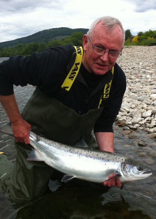 This happy River Tay salmon fisher hook, played and landed this perfect fresh run Spring salmon during late May in the Meetings Pool of the Kinnaird Beat near Dunkeld. A high rod tip is essential while playing a powerful fish like this to avoid a drowned fly line which could exert too much pressure on the hook hold.