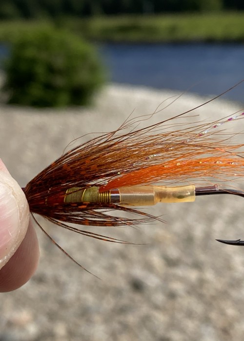 This pattern is rigged up with a hard plastic sleeve to keep the Partridge Nordic single hook straight for effective hook sets. This Jock's Shrimp salmon fly is the brown wing version and is tied on an aluminium tube fly body.