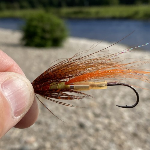 This pattern is rigged up with a hard plastic sleeve to keep the Partridge Nordic single hook straight for effective hook sets. This Jock's Shrimp salmon fly is the brown wing version and is tied on an aluminium tube fly body.