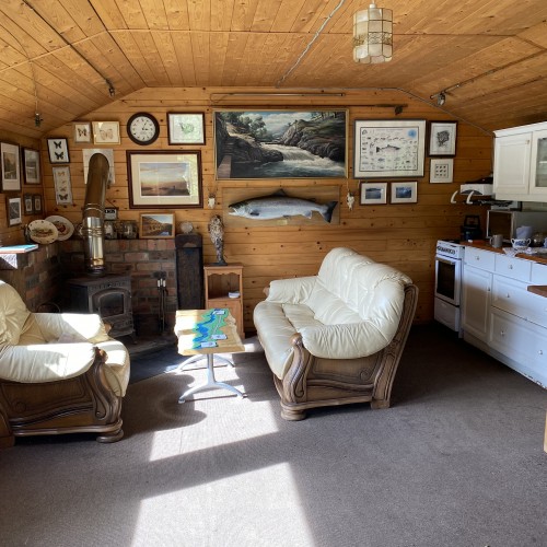This is the well appointed interior of the Dalmarnock Beat fishing hut on the River Tay near Dunkeld. You'll see the wood burning stove over in the corner which is worth its weight in gold in the cold weather of early Spring.